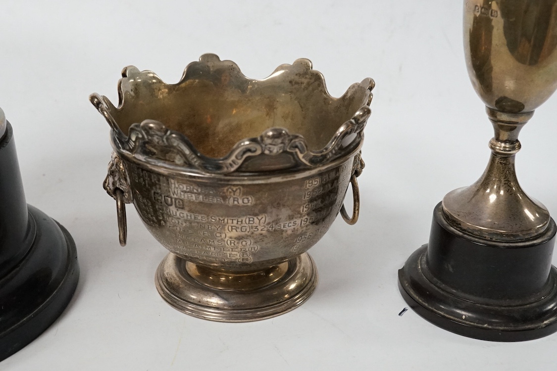A late Victorian silver miniature presentation two handled 'Monteith' bowl, with engraved inscription, Wakely & Wheeler, London, 1900, height 73mm, together with two later silver presentation trophy cups, 12.8oz. Conditi
